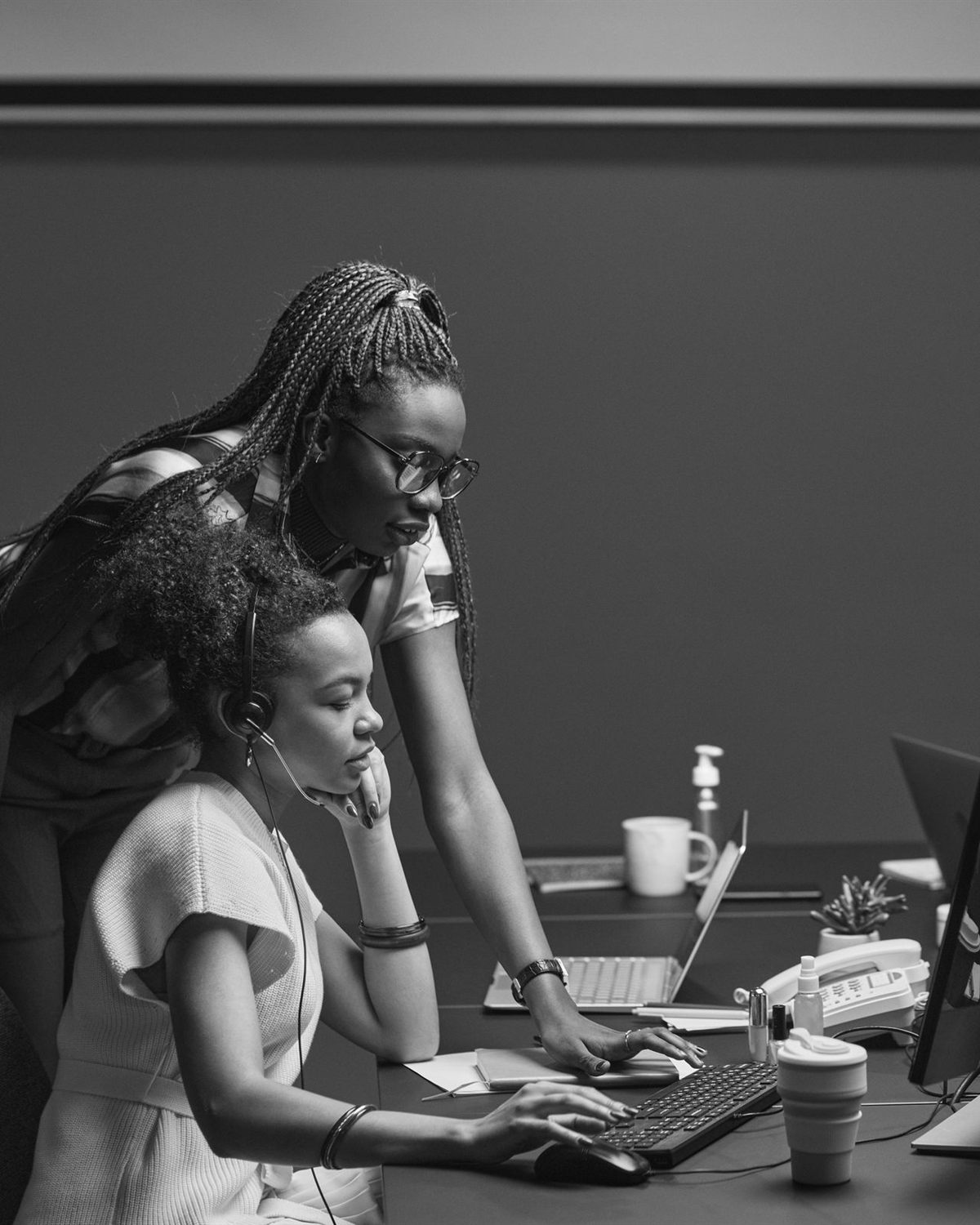 Two members of the recovery team working through an account together